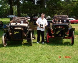 1906 Cadillac Model K Runabout 2006-06-21 DSC00837 Dick standing with his two entries at the 2006 Cadillac LaSalle New England regional meet. Dick called them "two hundred years of history", as each car is 100...
